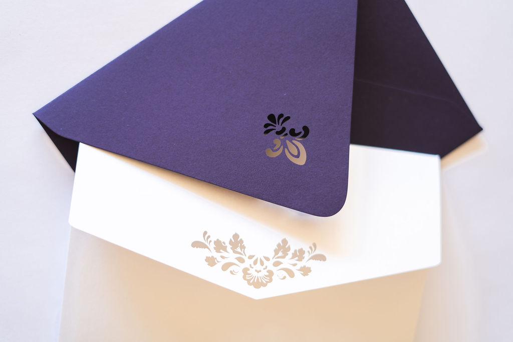 White and purple envelopes with pointed flap and euro flap styles and diecuts.