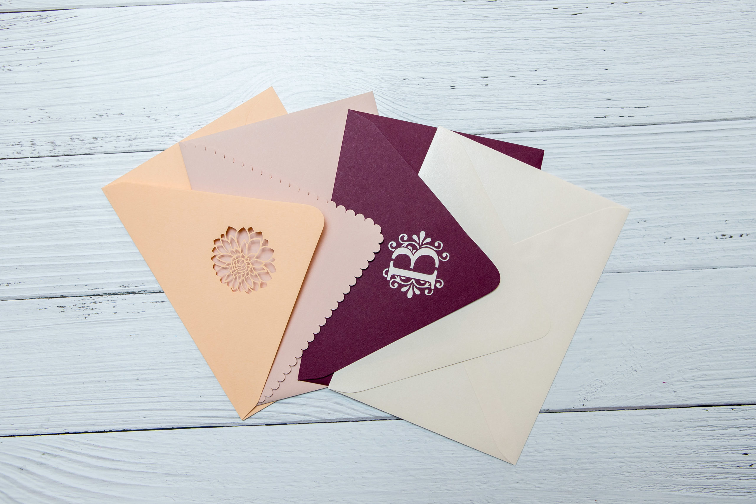 four die cut envelopes in warm colors