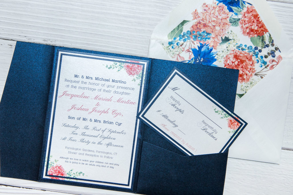 Navy blue and pink floral wedding invitation with envelope liner and pocket fold embellishments.
