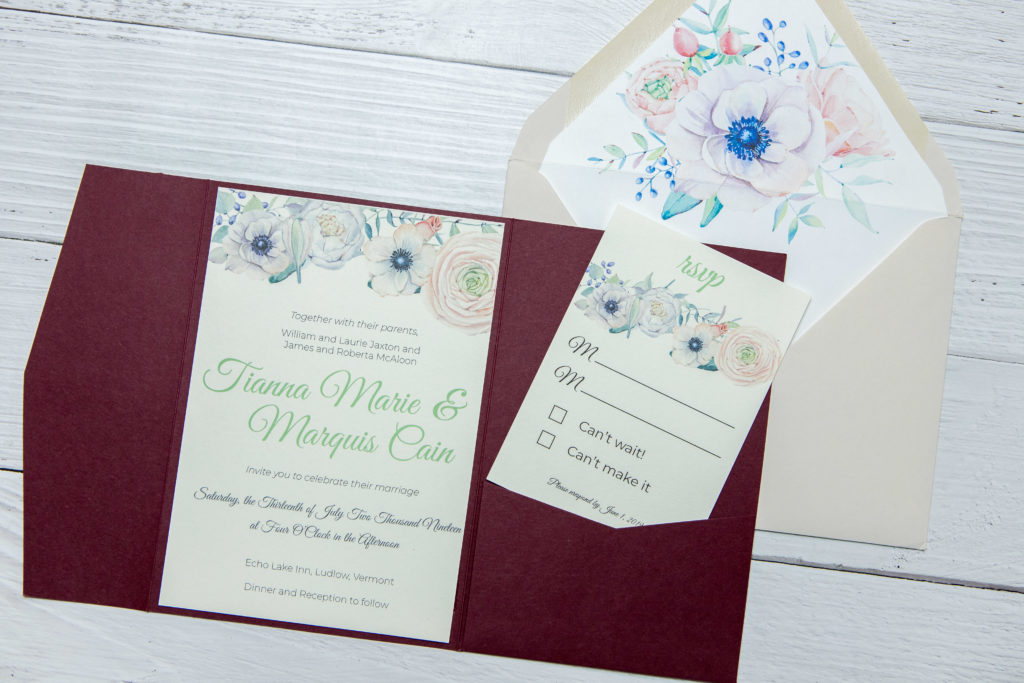 Floral wedding invitation with deep red pocket fold embellishments.