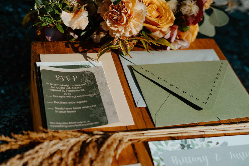 Green earthy wedding stationery suite including envelope and RSVP card.