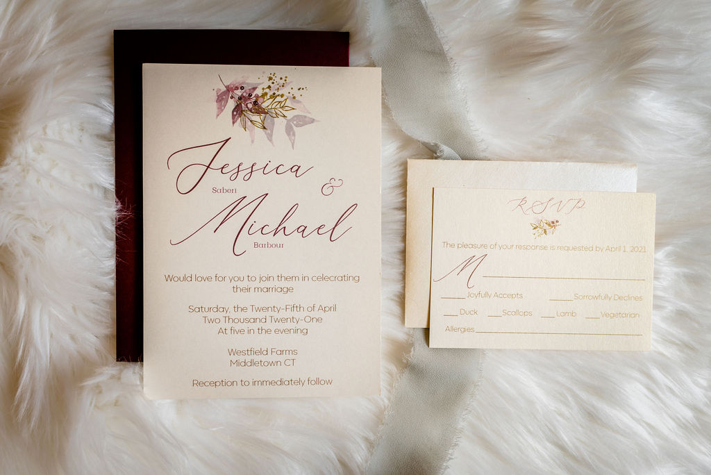 Pink gold and wine red wedding invitation and RSVP card on top of white faux fur background