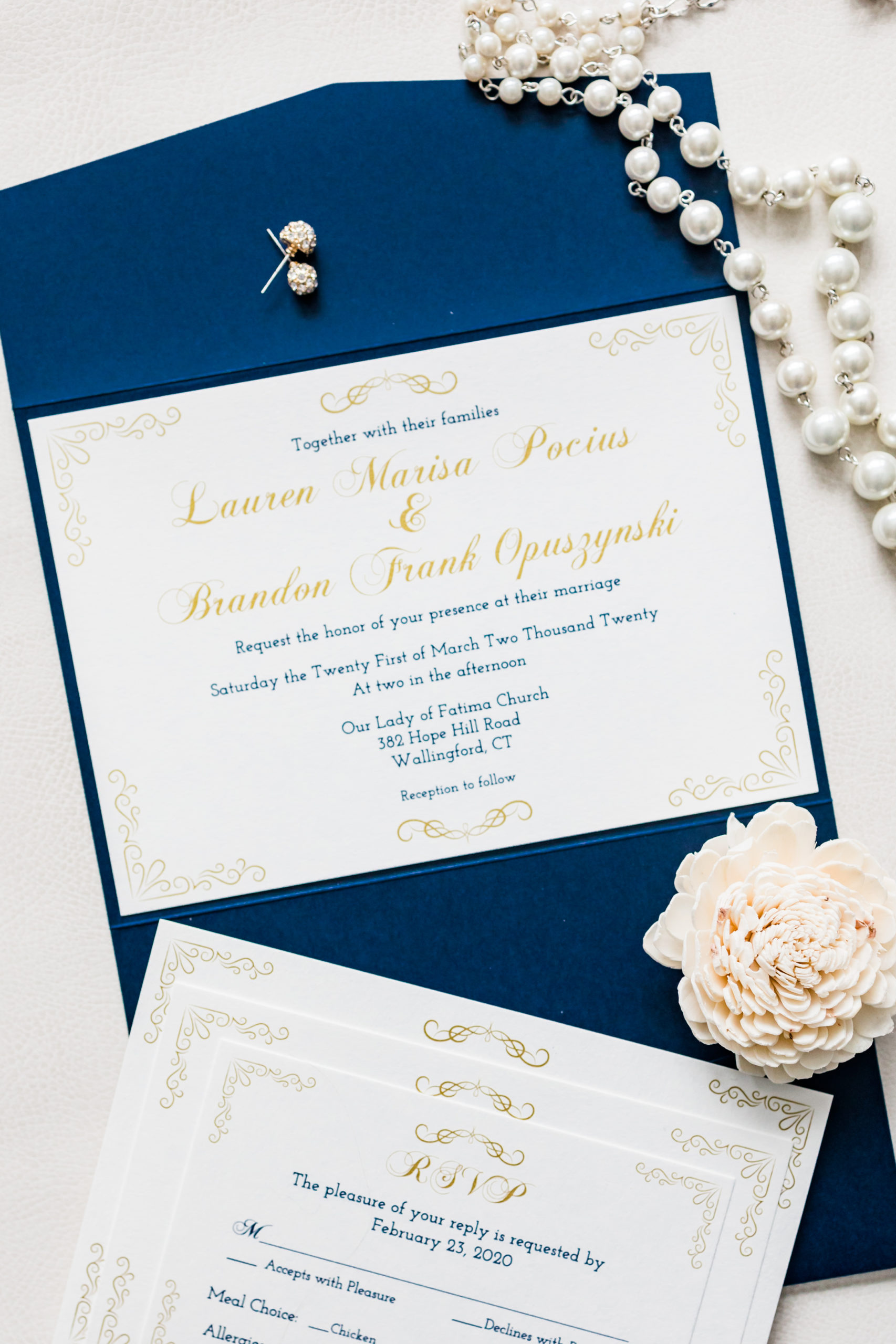 Sapphire blue and gold formal wedding invitation with flower and pearls