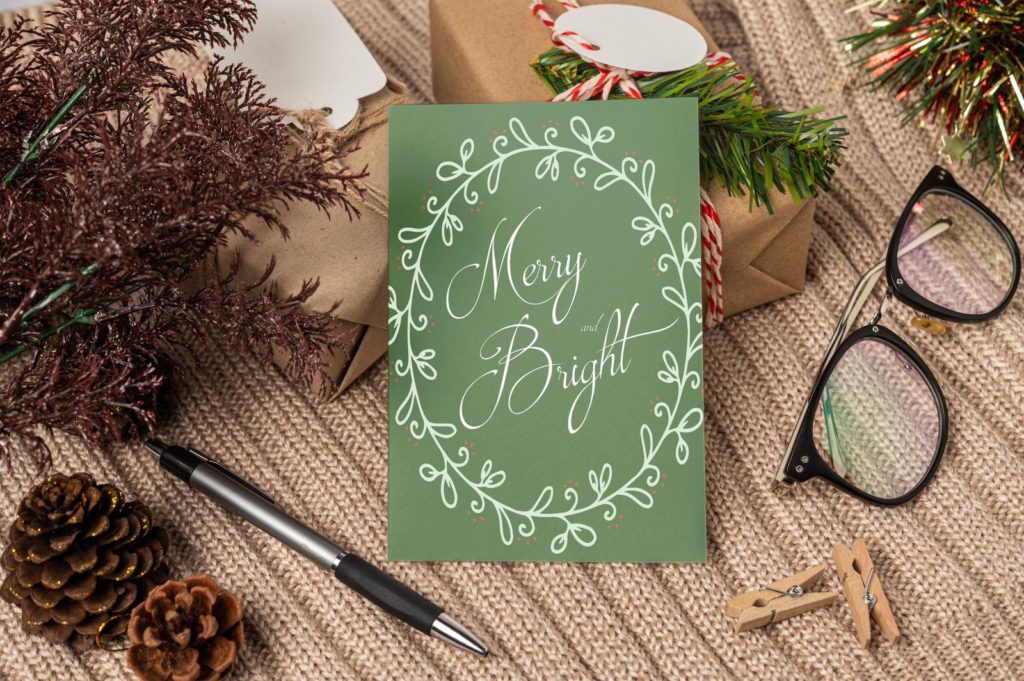 Custom green holiday card with phrase "Merry and Bright" written. 
