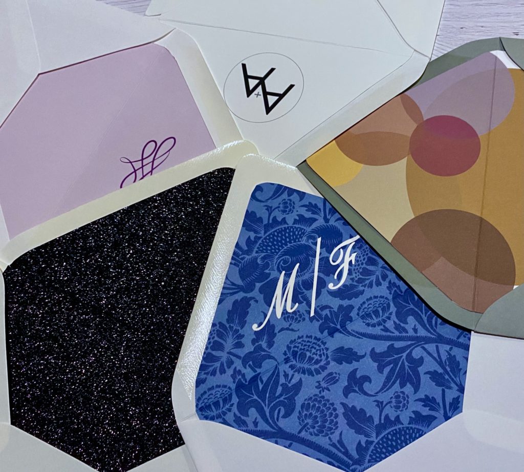 Selection of different envelopes with colorful liners, monograms, and designs.