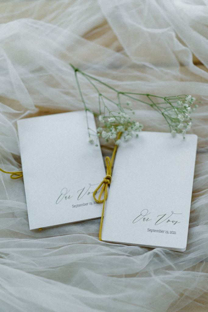 White wedding vow books tied with twine
